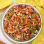 A bowl of homemade gluten free salsa with tortilla chips.
