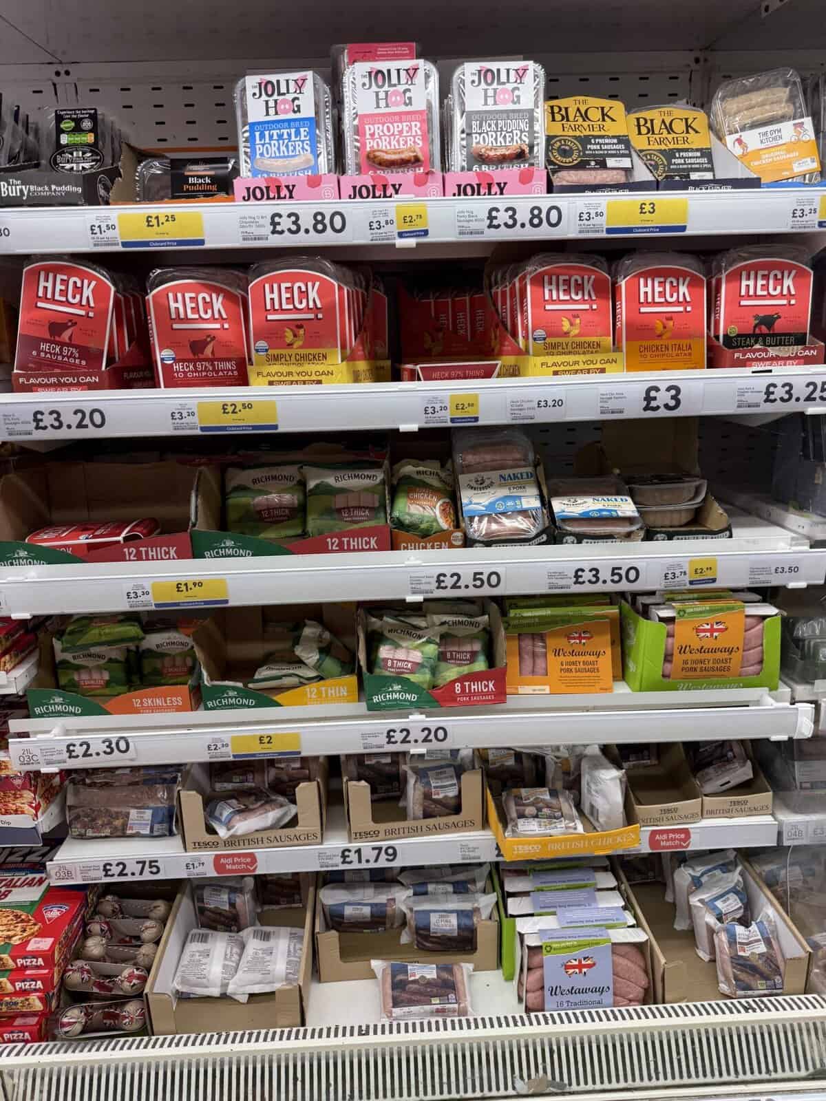 A supermarket shelf full of sausages.