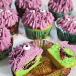 Gluten free monster cupcakes with a green sponge and jammy centre.