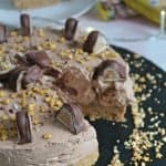 A gluten free kinder bueno cheesecake with a slice taken out.
