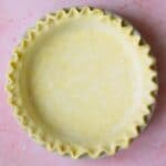 A crimped gluten free pie crust before baking.