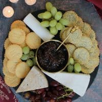 A cheeseboard filled with gluten free crackers.