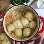 A pan filled with gluten free casserole and gluten free dumplings.