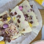 Slices of mini egg fudge on a wooden board.