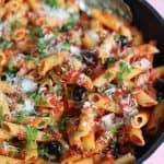 A pan of gluten free penne puttanesca.