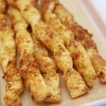 Gluten free cheese straws on a baking tray.