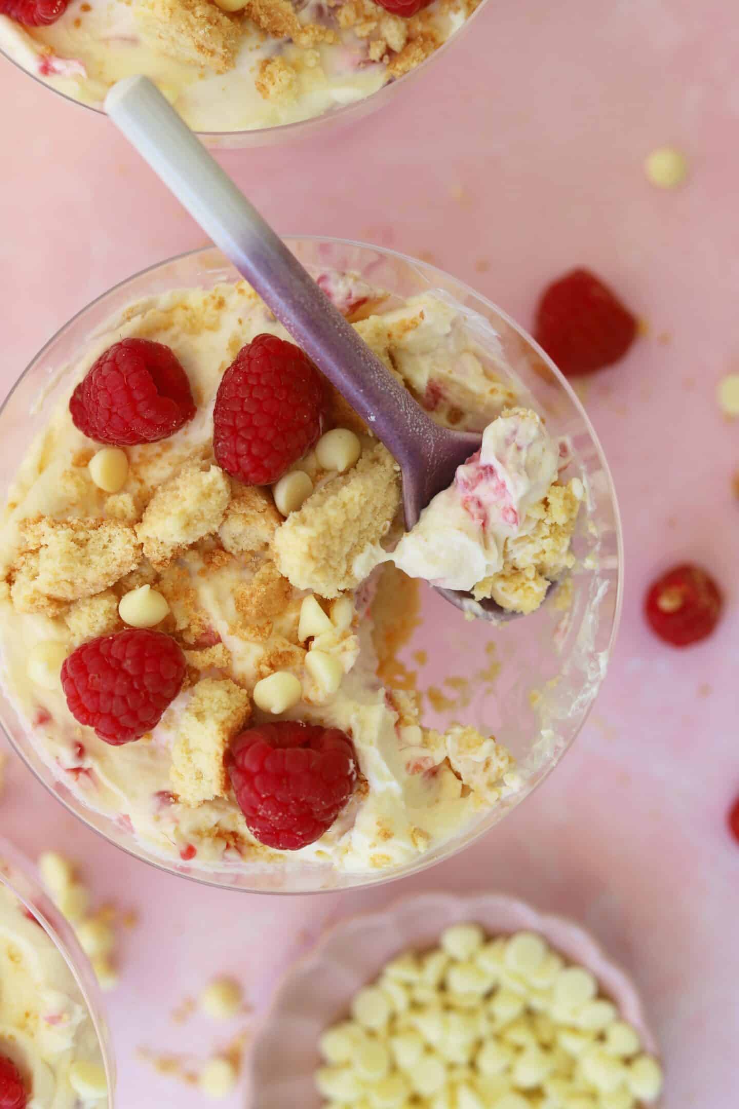 Overhead shot of a mini cheesecake pot with a spoonful taken out.