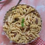 A bowl of sun dried tomato pasta salad.