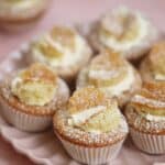 A pink plate with gluten free butterfly cakes on.