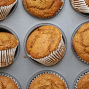 Pumpkin banana muffins in a baking tin.