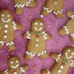 Gluten free gingerbread men on a purple background.