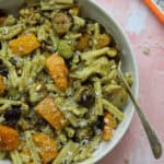 A bowl of roasted butternut squash pasta with pesto.
