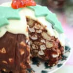 A Christmas pudding rocky road with a slice cut out of it.