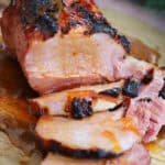 A slow cooker gammon on a board with marmalade glaze.