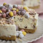 A mini egg cheesecake with a slice cut from it.