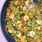 A pan of Singapore fried rice with prawns.