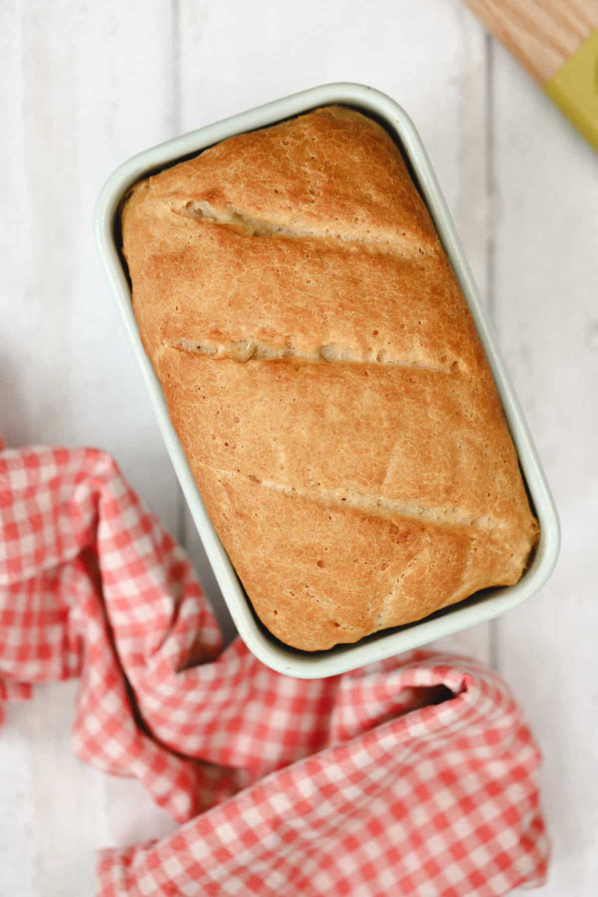 Overhead shot of a loaf of gluten free bread in the tin.