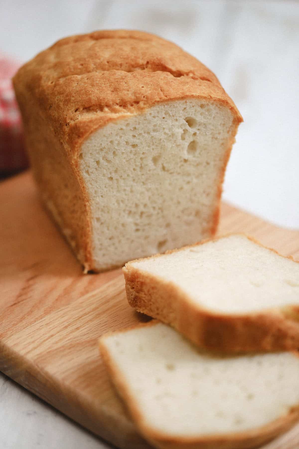 A loaf of gluten free caputo flour bread with two slices taken off.
