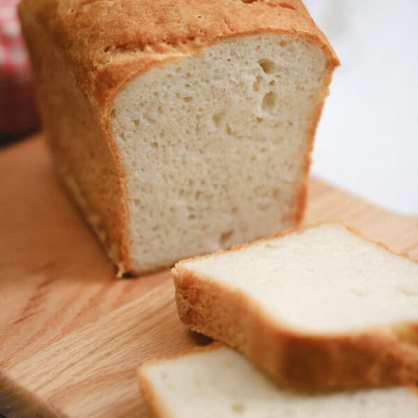 A loaf of gluten free caputo flour bread with two slices taken off.
