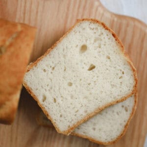 Close up of slices of caputo gluten free bread on a wooden board.