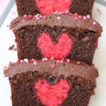 Slices of chocolate cake with a hidden pink heart in the centre.