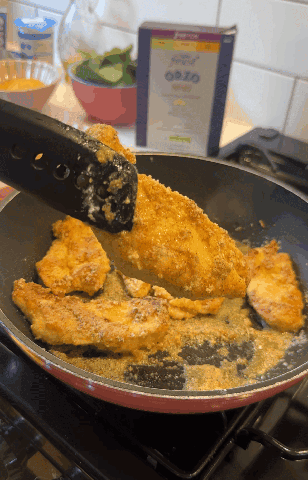 Fry the coated chicken breast until golden then remove from the pan.