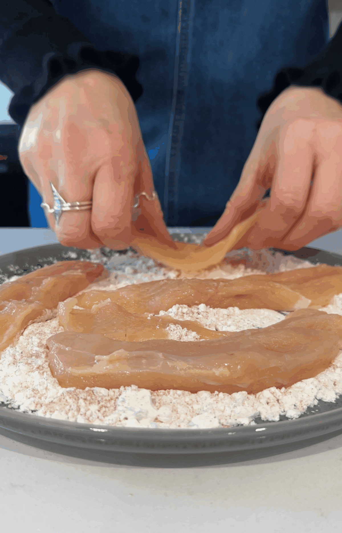 Coat the butterflied chicken breasts in cornflour.