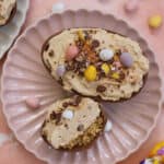 An Easter egg cheesecake on a pink plate.