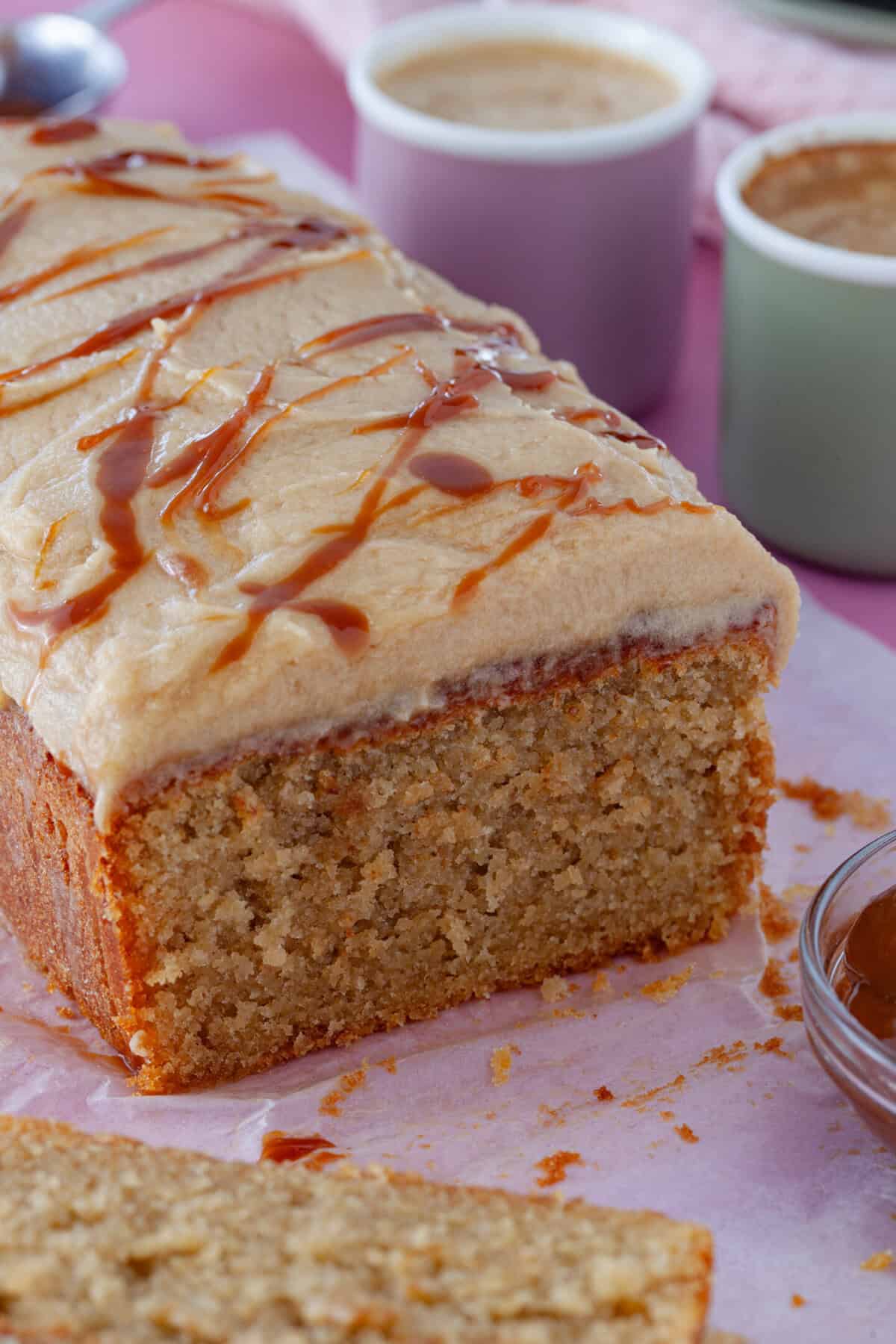 A gluten free caramel latte cake with a slice cut out.