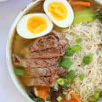 Close up of a bowl of gluten free ramen with noodles, steak and eggs.