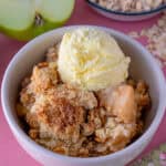 A bowl of gluten free apple crumble with ice-cream.