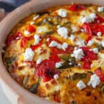 A sweet potato, roasted red pepper and feta frittata in a dish.