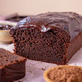 Cross section of a chocolate coffee cake with a slice taken off.