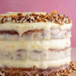 A gluten free hummingbird cake decorate with pecan nuts.