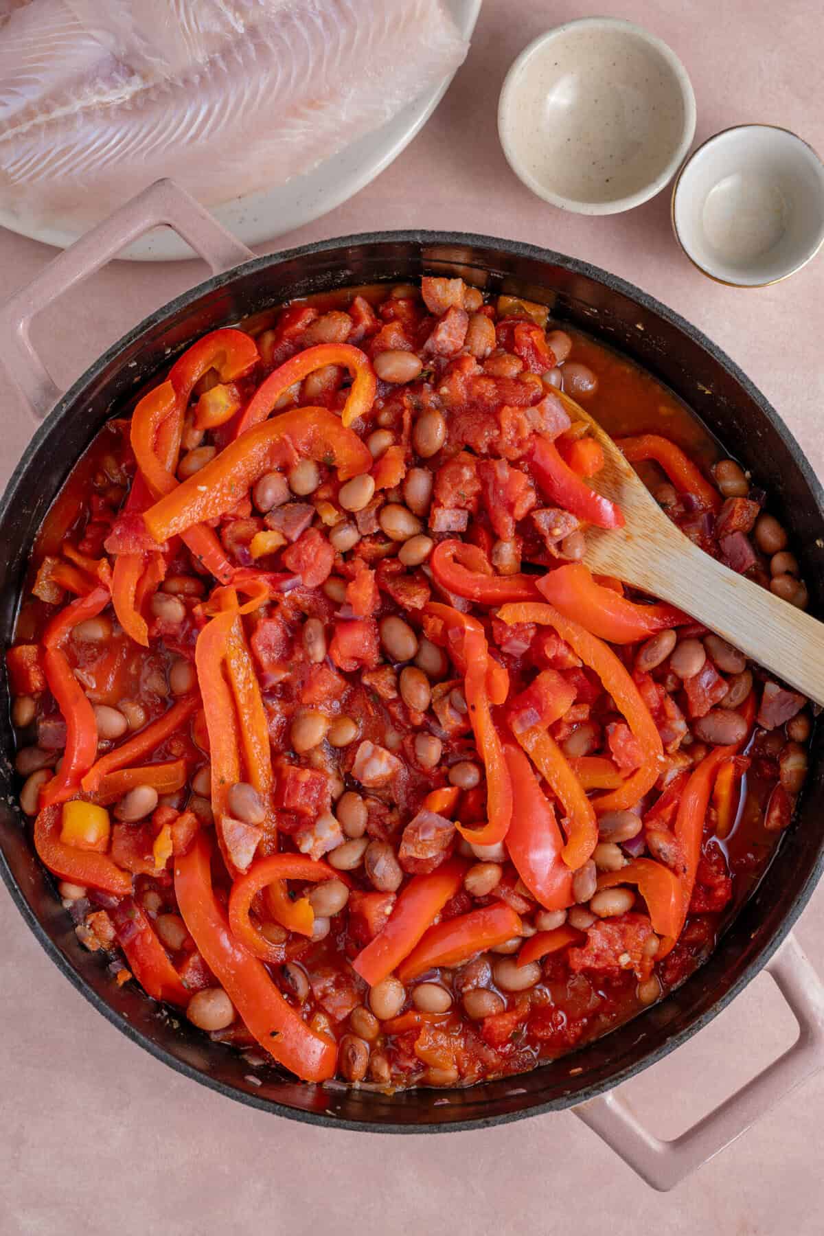 Add the red peppers, beans and tinned tomatoes to the pan.