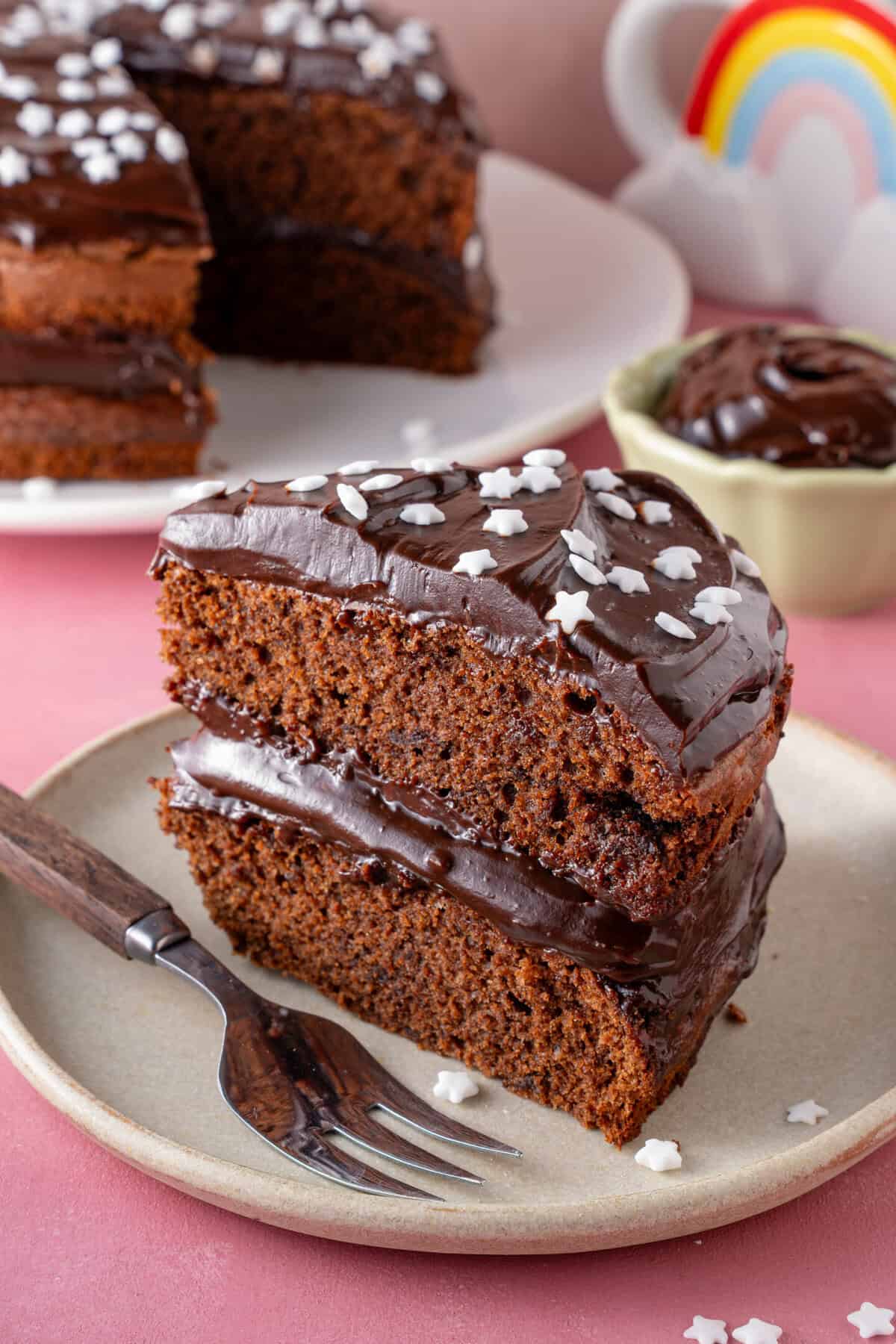 A slice of gluten free chocolate cake on a plate.