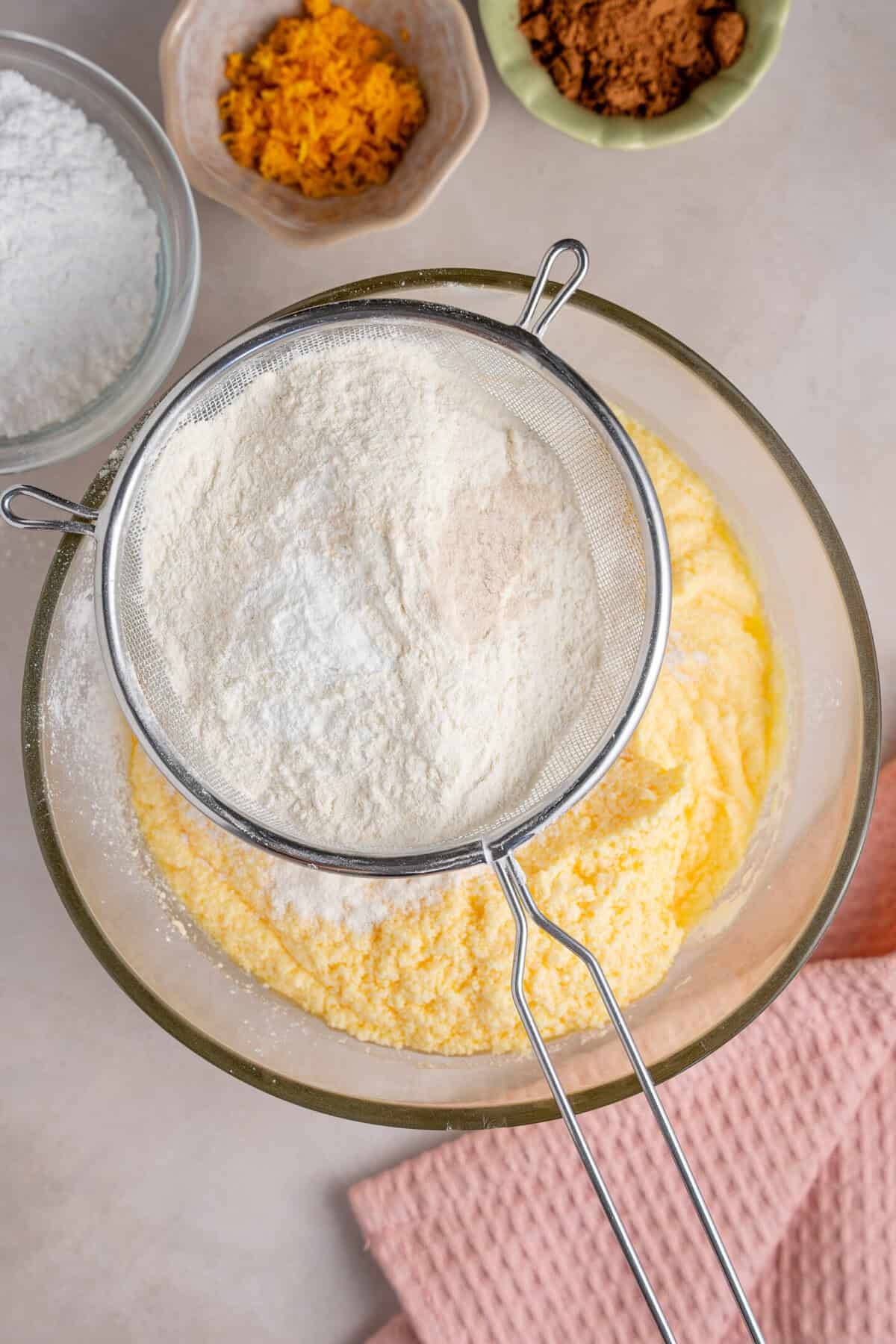Adding gluten free flour to the cake batter.