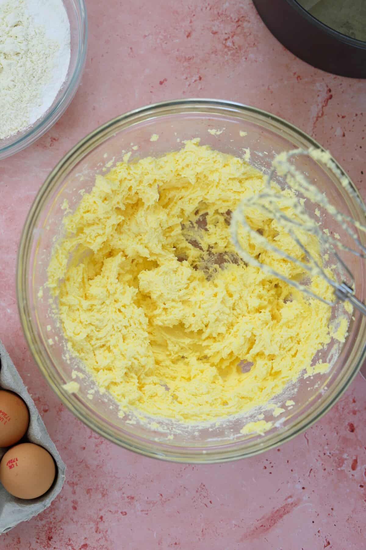 Creaming butter and sugar together in a glass mixing bowl.