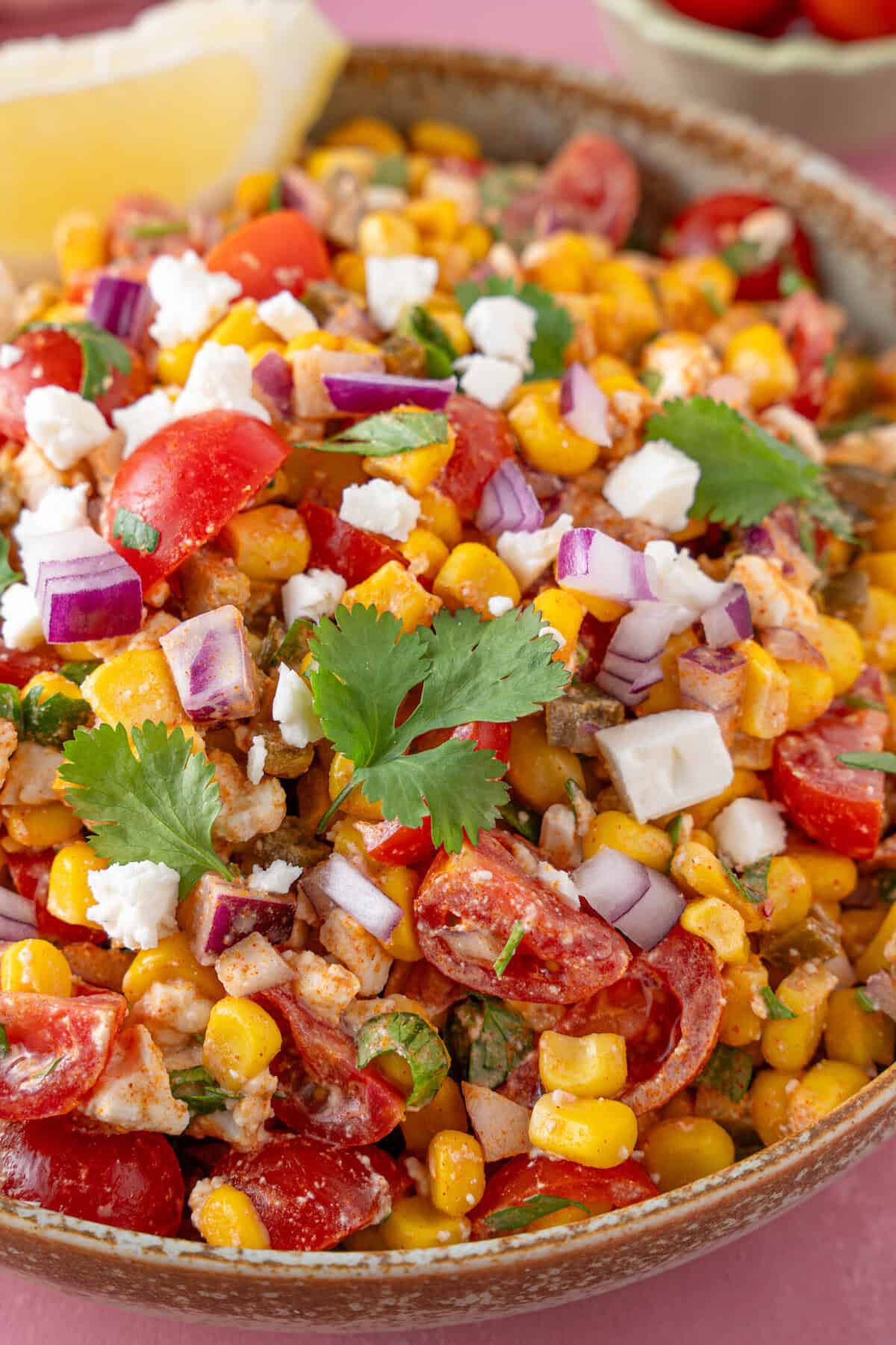 Close up of a bowl of Mexican corn salad.