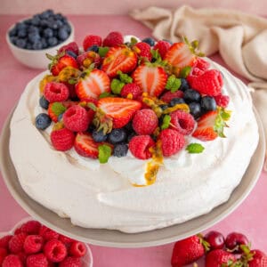 A gluten free pavlova topped with summer berries.