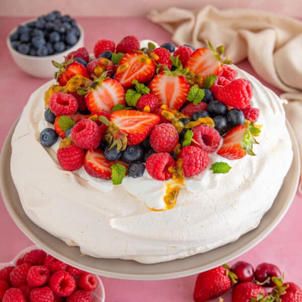 A gluten free pavlova topped with summer berries.