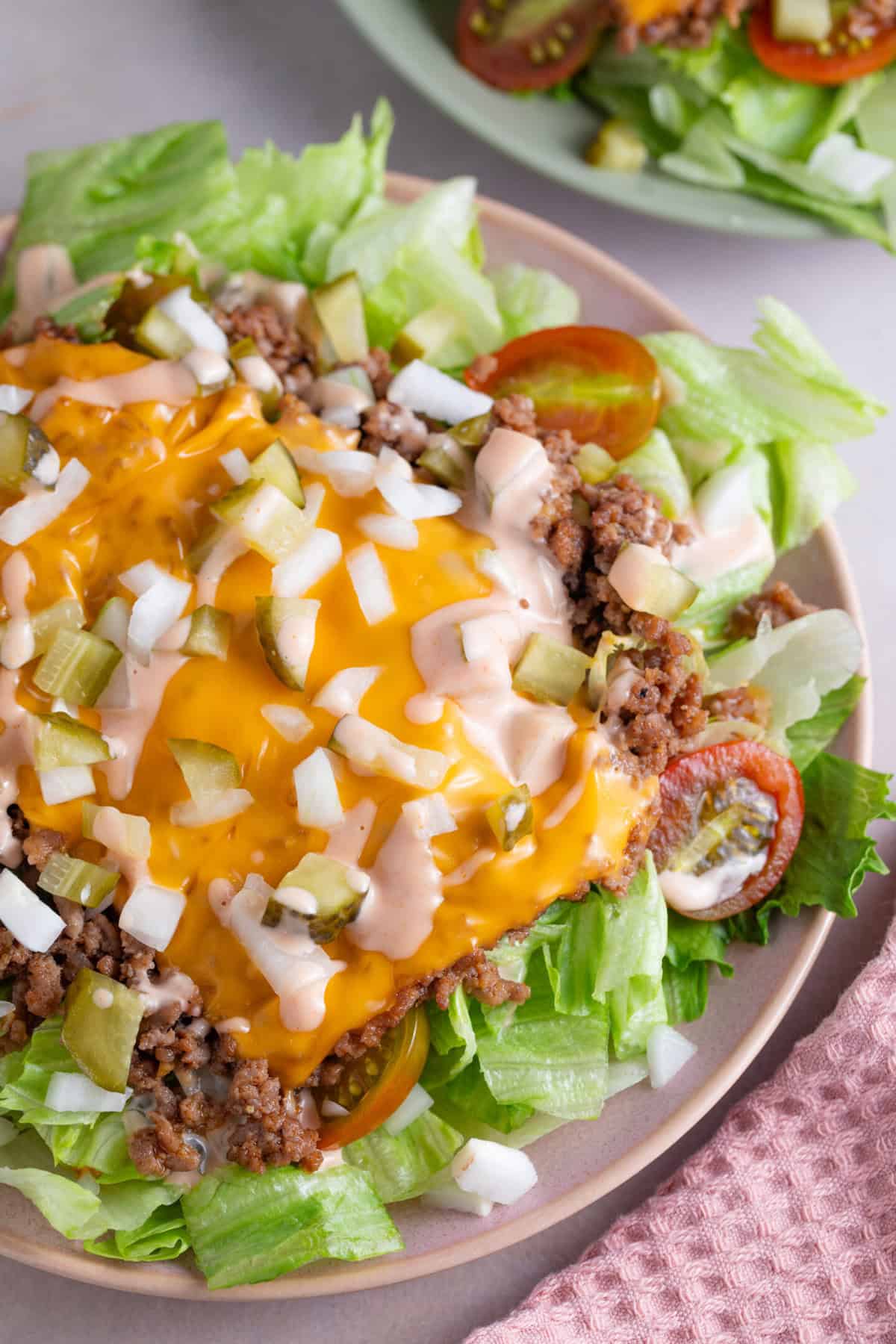 Close up shot of a big mac salad with iceberg lettuce, mince, burger cheese and onion with big mac sauce.