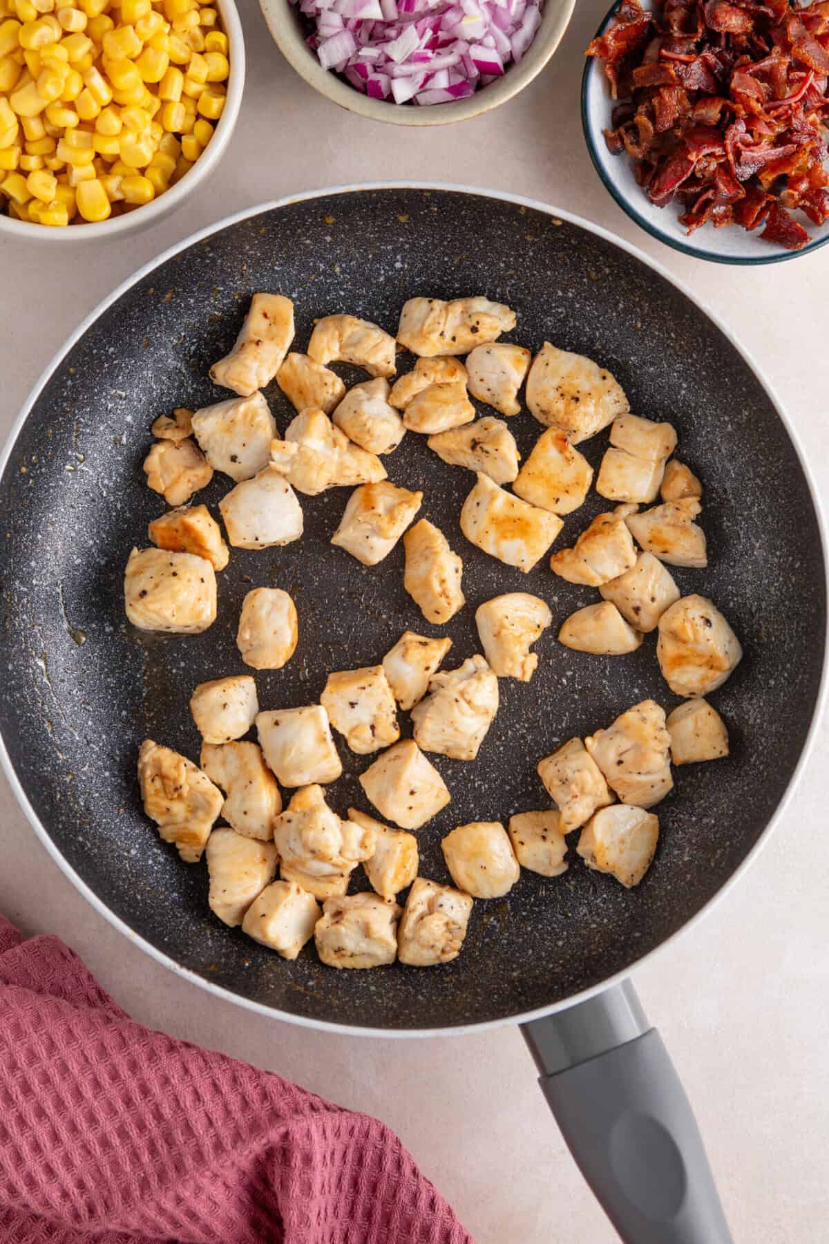 Chicken chunks in a pan.