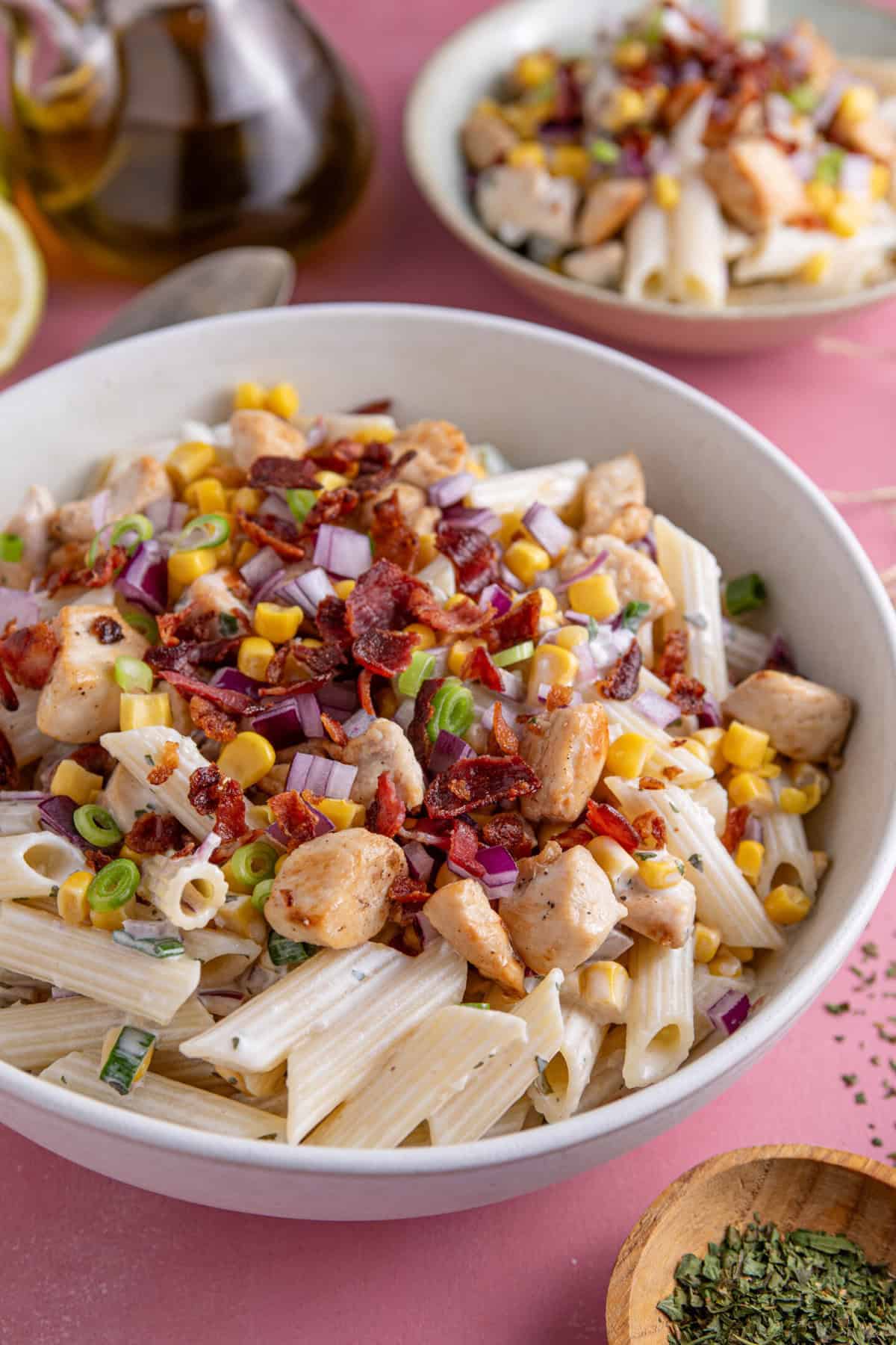 A bowl of chicken and bacon pasta salad.