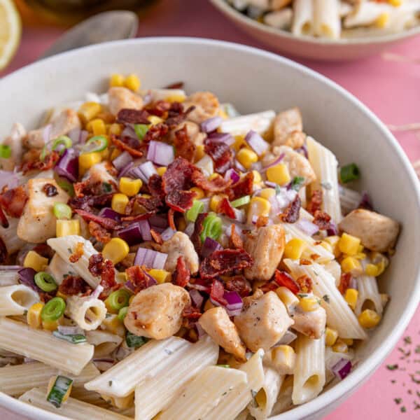 A bowl of chicken and bacon pasta salad.