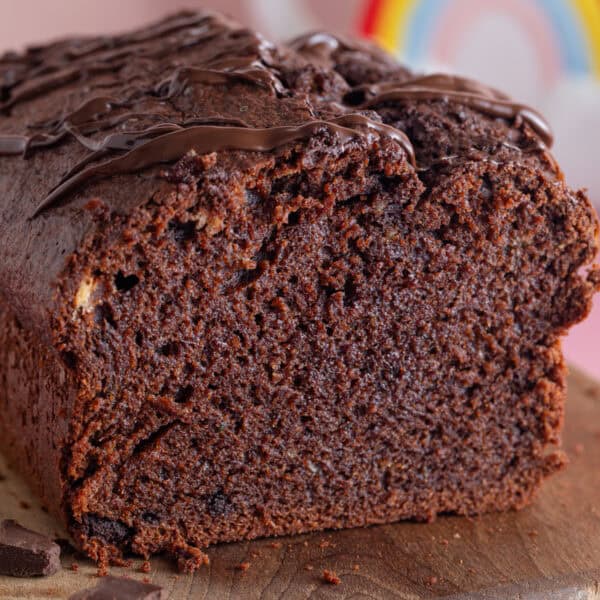 A gluten free chocolate courgette cake with a slice taken off showing the cross section.