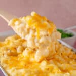 A spoon lifting out a serving of gluten free mac and cheese.