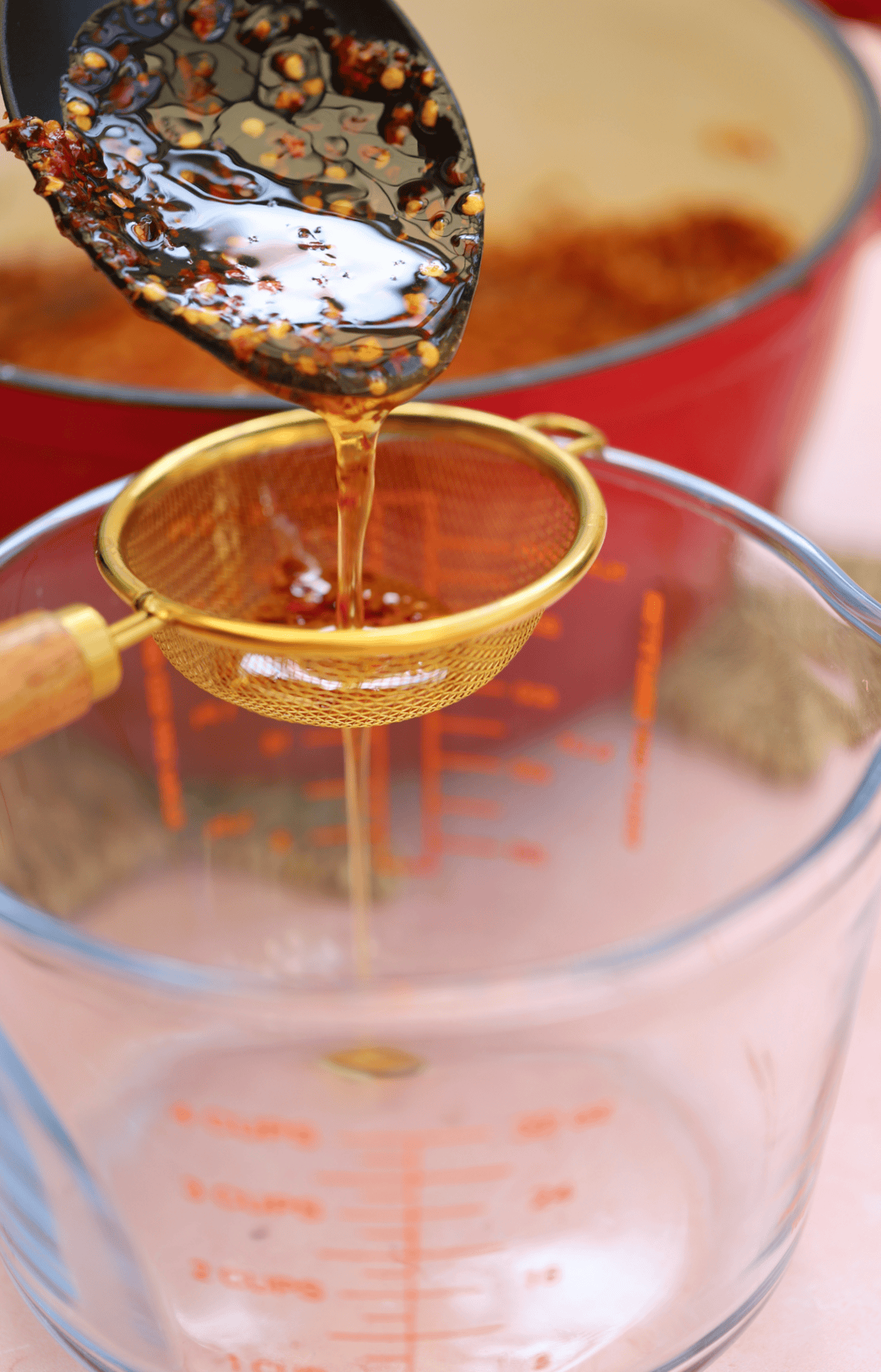 Pour the hot honey through a fine sieve to strain off the chilli flakes.