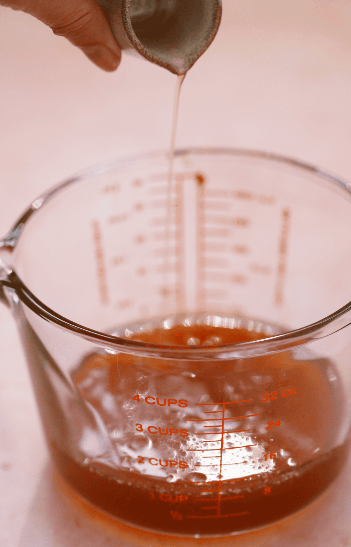 Add the apple cider vinegar before cooling and storing the hot honey.