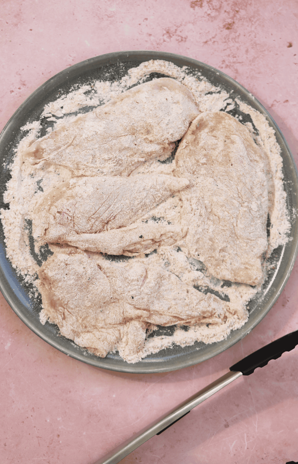 Coat the chicken breasts in the flour mix.